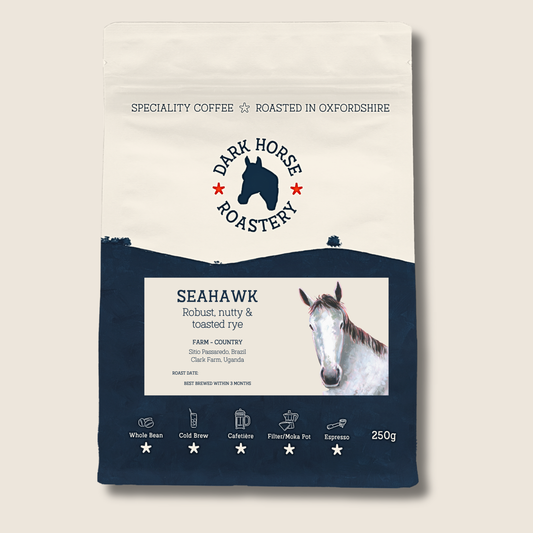Coffee bag from Dark Horse Roastery with horse imagery on a beige background